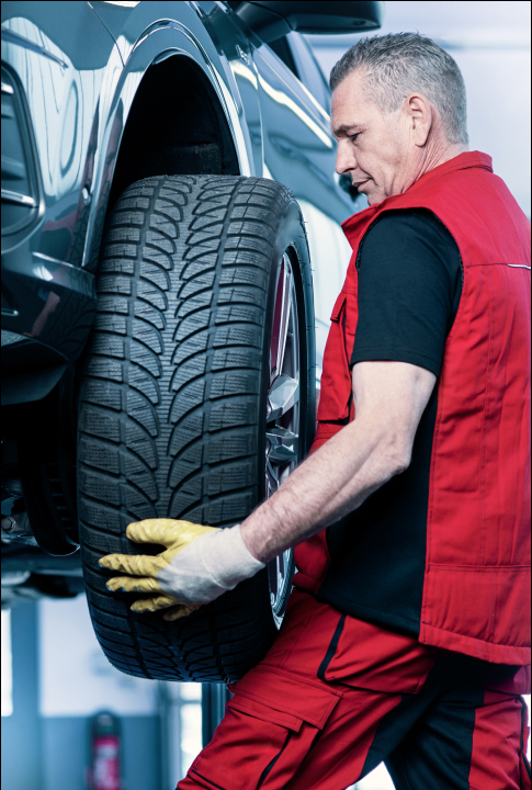 A mechanic changing a tire at our New Orleans auto repair shop